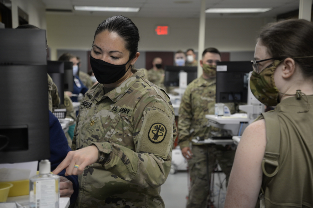 Photo of military health care providers using the EHR to provide care