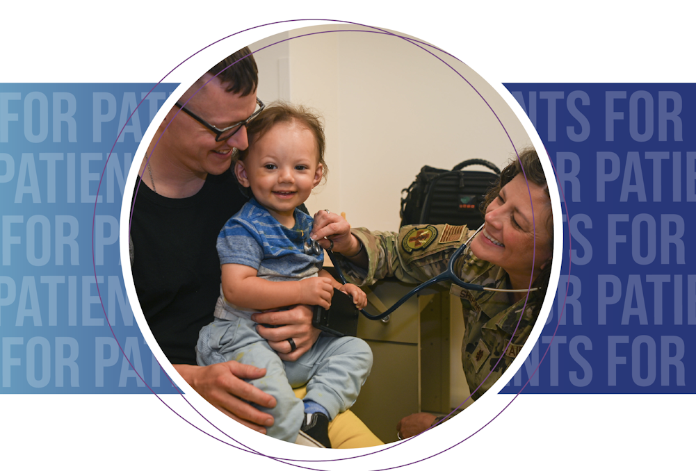 A doctor uses a stethoscope to listen to a child's heart and lungs while the child is held by another adult.